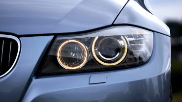close-up photo focused on the headlights of a luxury car